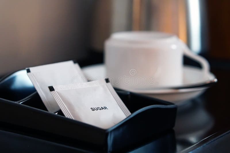 White Sugar Packet with Coffee Cup and Kettle Set in Hotel Room Stock