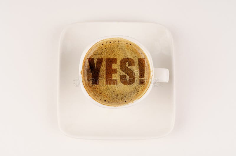 On a White Surface There is a White Cup with Coffee, on the Coffee Foam