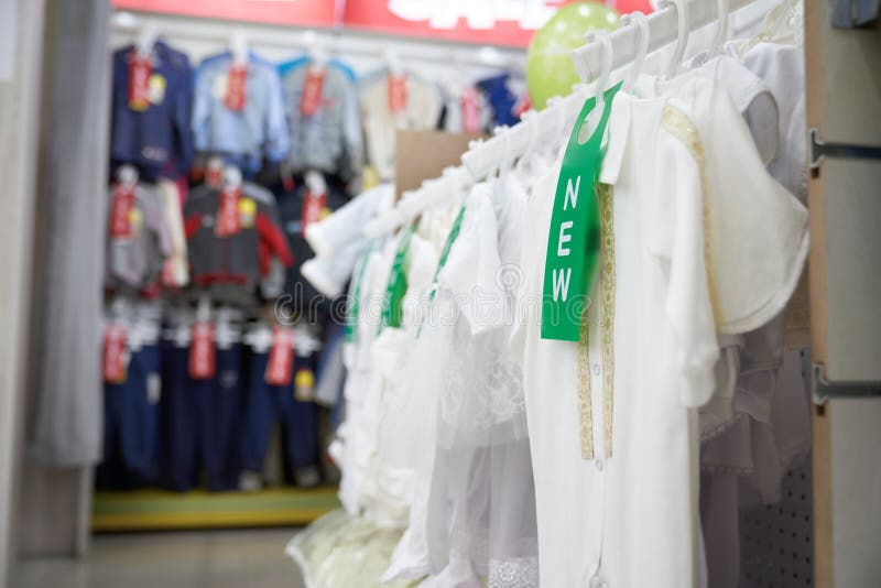 White T Shirt for Kids on Hangers in Clothing Store. Stock Image