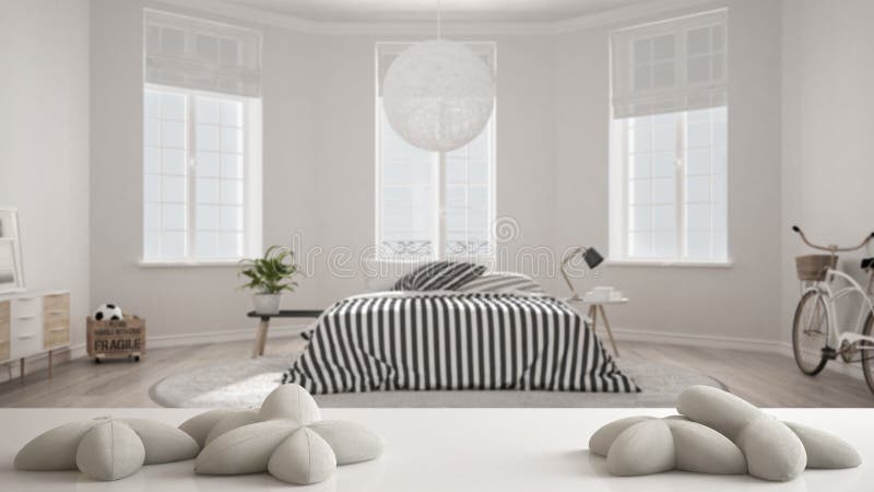 White table, desk or shelf with five soft white pillows in the shape of stars or flowers, over blurred scandinavian bedroom, white stock images White table, desk or shelf with five soft white pillows in the shape of stars or flowers, over blurred scandinavian bedroom, white stock images