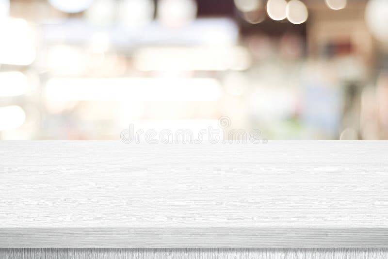 White table presentation, desk and blur background, Empty wood counter, shelf surface over blur restaurant white bokeh background royalty free stock image