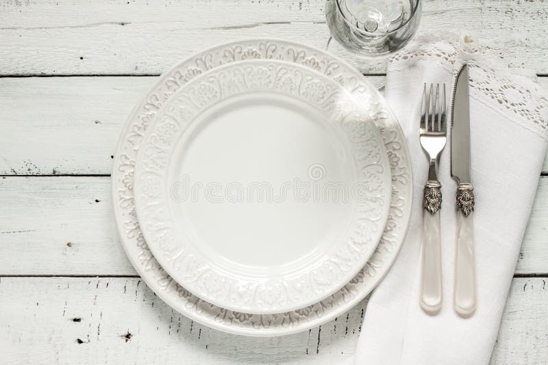 White table setting from above with elegant empty plate stock photos