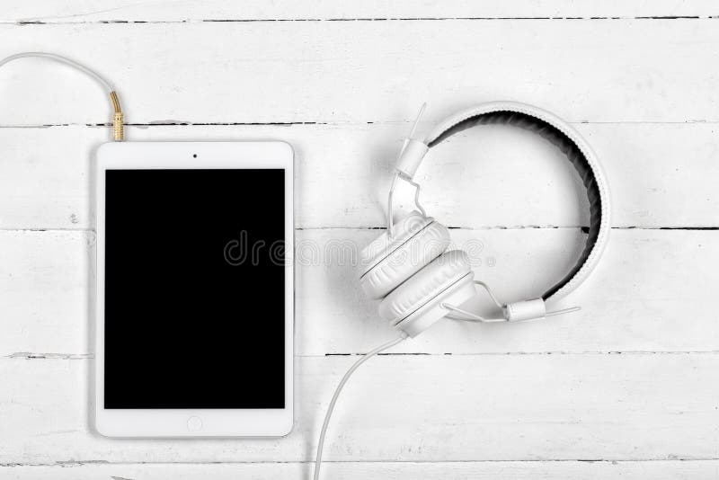 White tablet computer and the white headphones