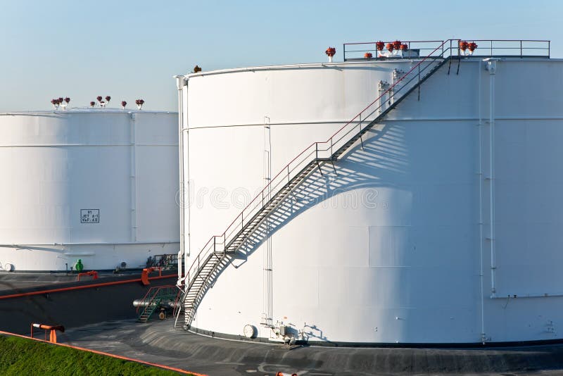 White tanks in tank farm with blue sky