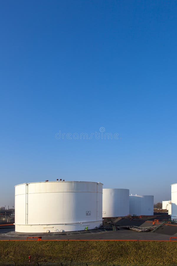 White tanks in tank farm with blue sky