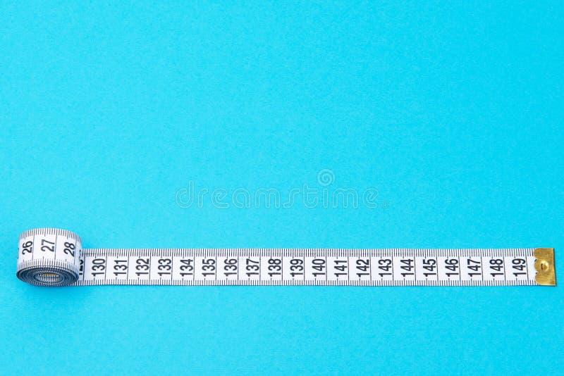 White Tape Measuring on a Blue Background with Copyspace Stock Image