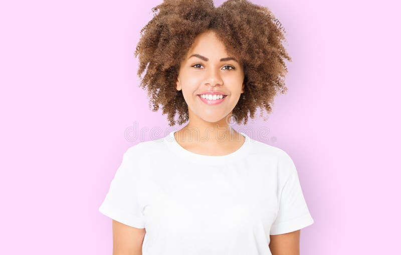 White teeth smile. Young african american woman with perfect skin care and curly afro hair isolated on pink background. Blank royalty free stock photo White teeth smile. Young african american woman with perfect skin care and curly afro hair isolated on pink background. Blank royalty free stock photo