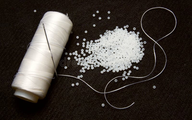 White thread with glass beads