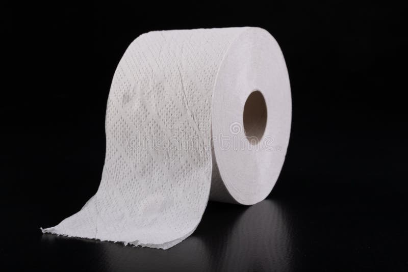 White toilet paper on a dark table. Articles for daily hygiene
