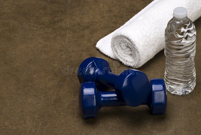 White Towel Blue dumbbells with a bottle of water