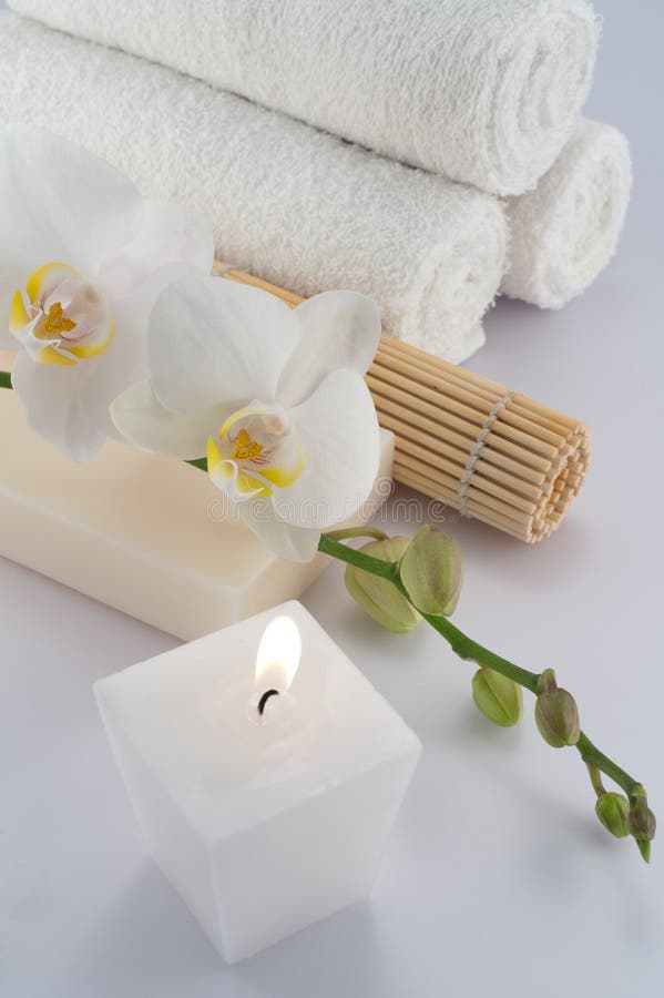 White towels, orchid and candle