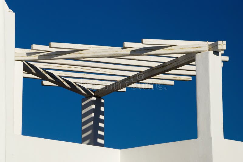 White Trellis With Shadows Against Blue Sky