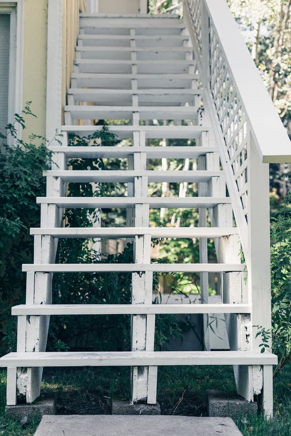 White vintage stairs outside of the house around the green plants stock photography White vintage stairs outside of the house around the green plants stock photography