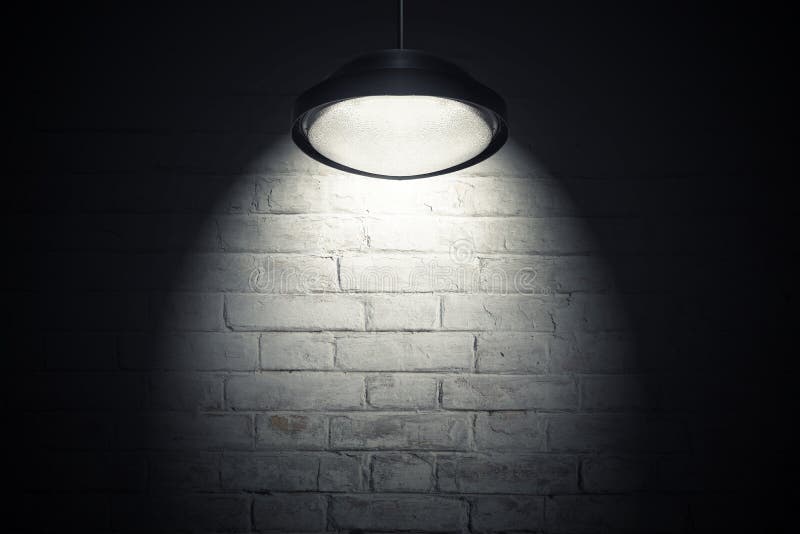 White wall illuminated with spot light. White brick wall illuminated with spot light from the ceiling lamp. Dark interior as background with copy space stock image White wall illuminated with spot light. White brick wall illuminated with spot light from the ceiling lamp. Dark interior as background with copy space stock image