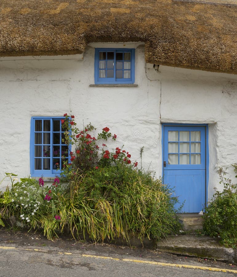 White-washed, stone cottage with thatched roof, Cadgwith, Cornwall, England