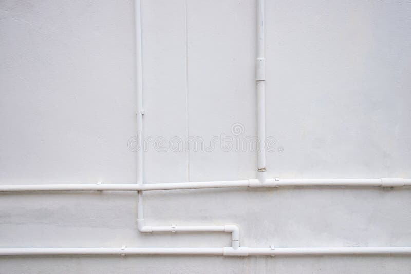 White Water Pipe System Installed on White Concrete Wall Stock Image