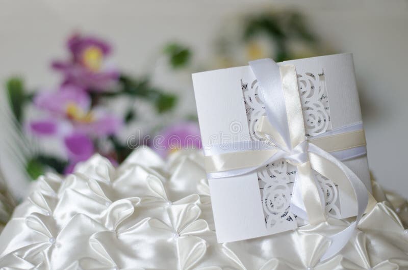 White Wedding Invitation on a Satin Pillow Stock Image Image of white