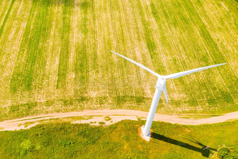 White wind turbine set in green field, aerial landscape. Farmland view royalty free stock photo White wind turbine set in green field, aerial landscape. Farmland view royalty free stock photo