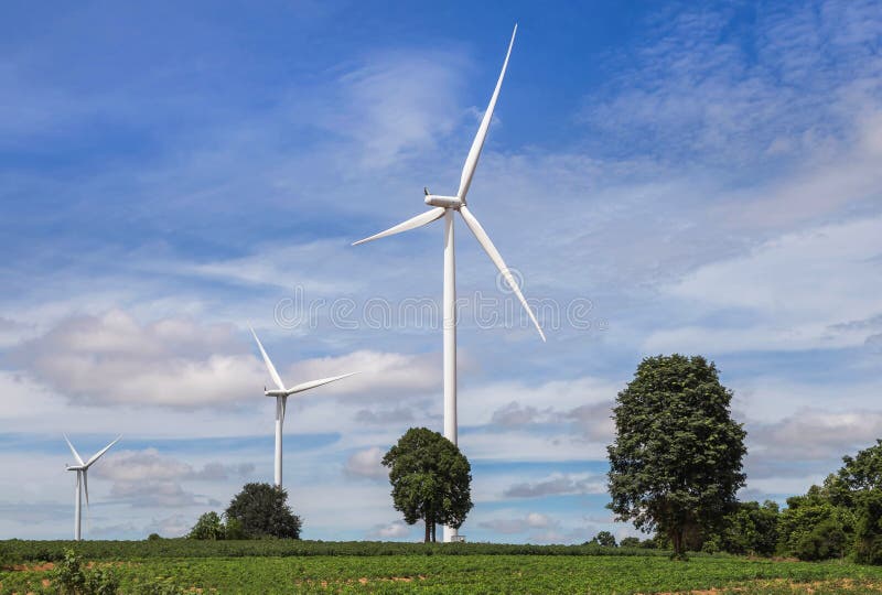 White wind turbines generating electricity in wind power station alternative renewable under blue sky backgroun stock photography White wind turbines generating electricity in wind power station alternative renewable under blue sky backgroun stock photography