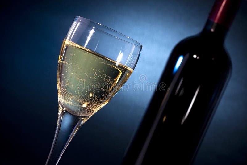 White wine on a glass closeup & a bottle