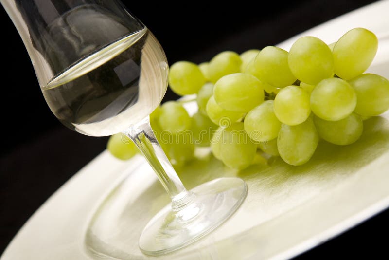 White wine and grapes on tray