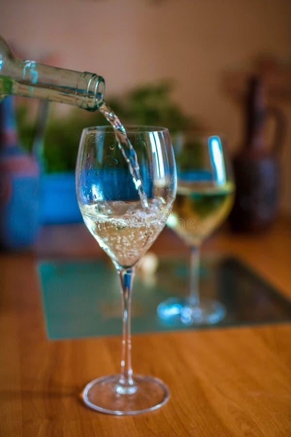 White Wine Pouring in To a Glass from a Bottle Stock Photo Image of