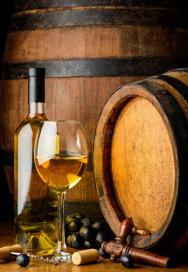 White wine on wooden barrel background