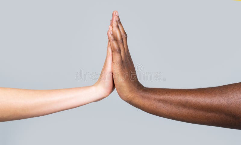 White Woman, African man giving high five, Friendship Symbol.Mixed race couple holding hands. High-five gesture and