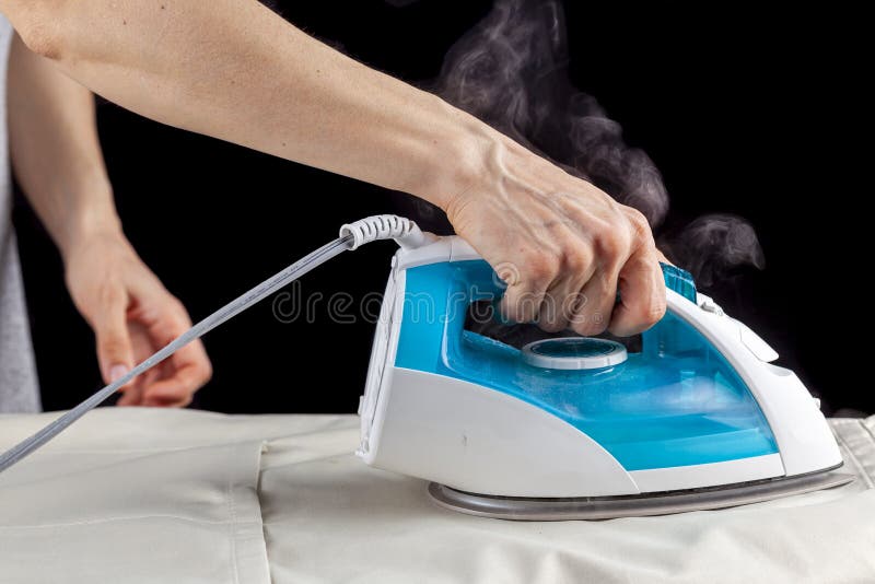 Close Woman's Hand Ironing Cloth Ironing Board Stock Photo by