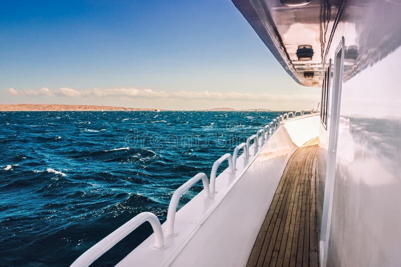 White yacht in the red sea at sunset