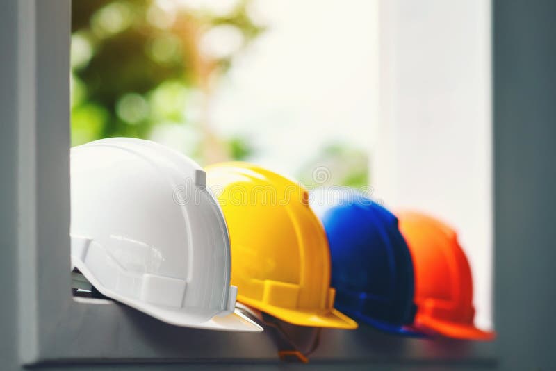 White, yellow and other colored safety helmets for workers` safety projects in the position of engineers or workers on concrete. Walls in the city royalty free stock images White, yellow and other colored safety helmets for workers` safety projects in the position of engineers or workers on concrete. Walls in the city royalty free stock images