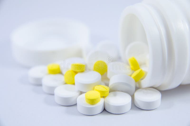 White and yellow pill on white blackground royalty free stock photo.