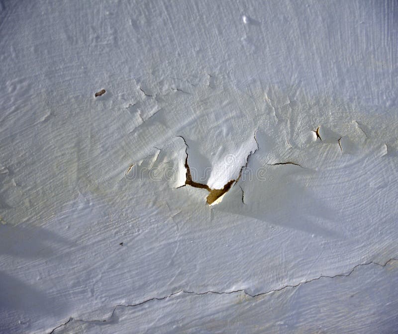 A Whitewashed Wall in the Bathroom with Cracks from Water Drips. Wall