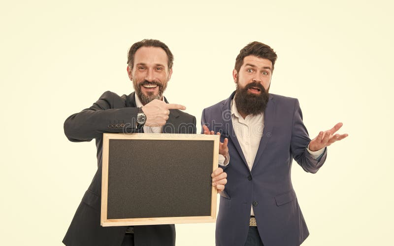 Who knows. Coaches hold blackboard pointing finger isolated on white. Professionally trained coaches. Bearded men back royalty free stock photography