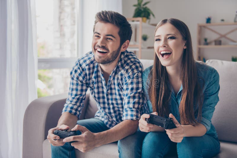 Who will win? Excited funny friends, playing video games at hom royalty free stock photography Who will win? Excited funny friends, playing video games at hom royalty free stock photography