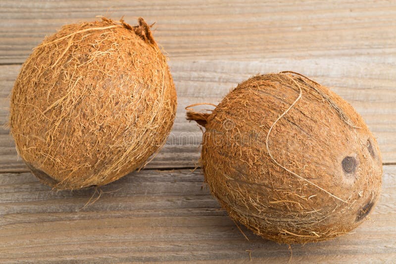 Whole coconuts on table stock photo. Image of tropical 63354940