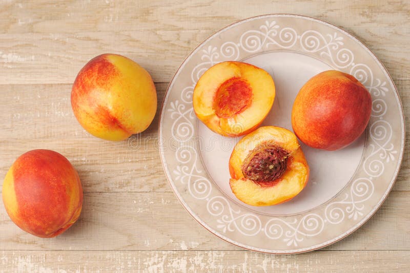 Whole and Cut Nectarine on a Plate Stock Image Image of yellow
