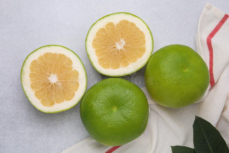 Whole and Cut Sweetie Fruits on Light Table, Flat Lay Stock Image