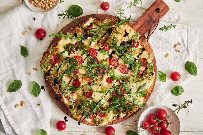 Whole Flatbread Pizza with Pesto and Salmon Topped with Tomatoes and