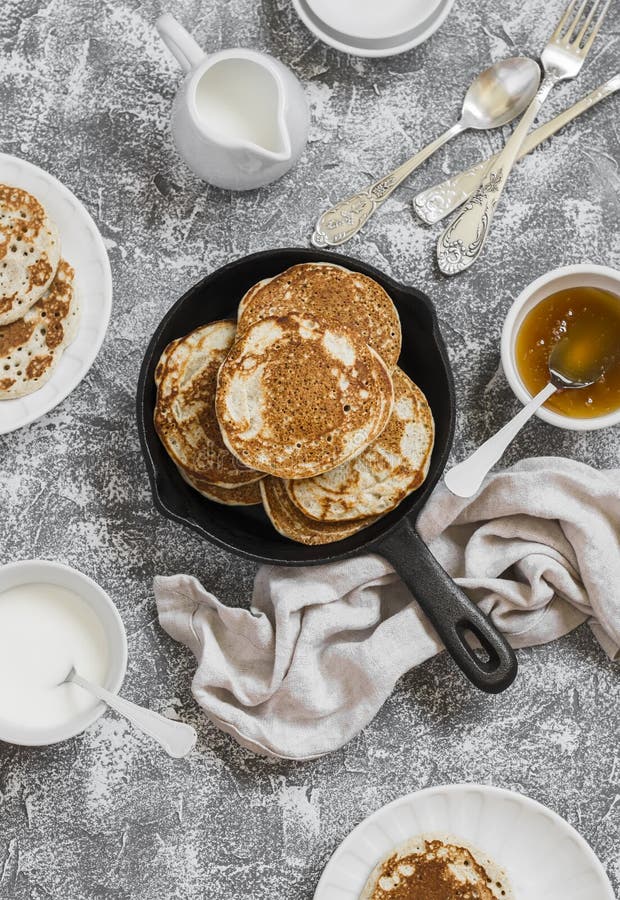 Whole Grain Pancakes in a Cast Iron Pan on a Stone Background. Stock