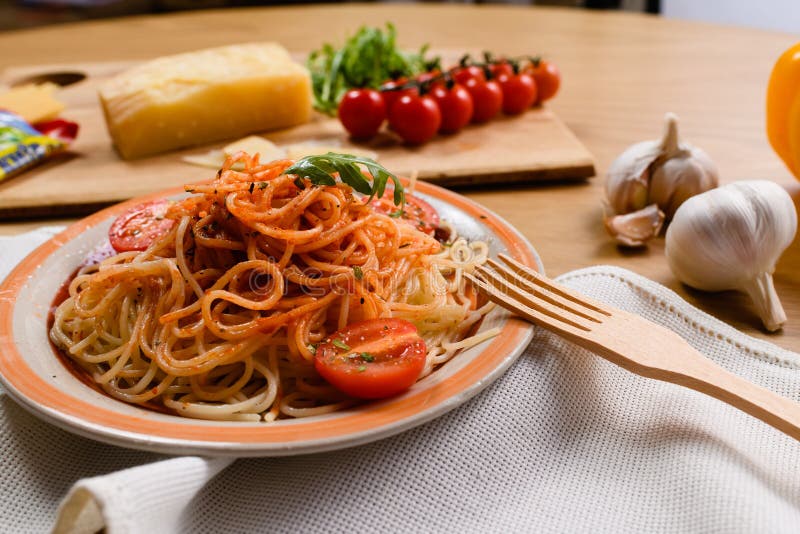 Whole Grain Spaghetti Pasta with Cherry Tomato in a Bowl Stock Photo