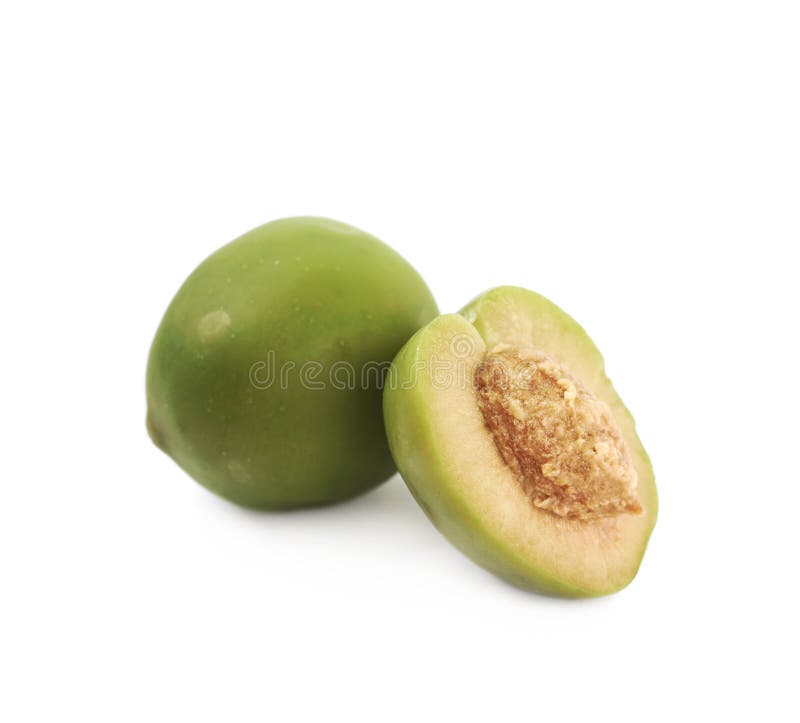 Whole green olive next to a sliced one