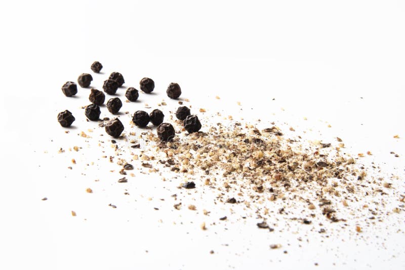 Whole and ground black pepper close-up