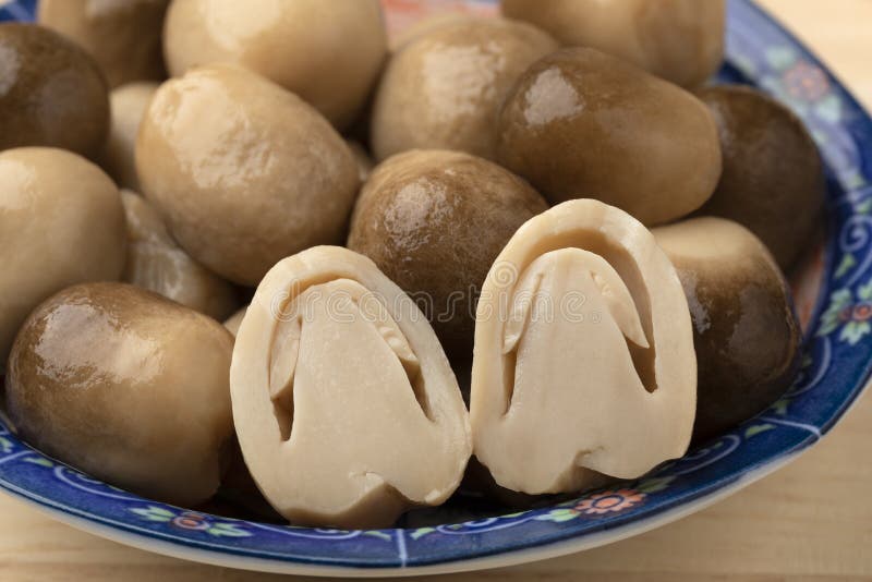 Whole and half straw mushroom in a bowl close up royalty free stock images
