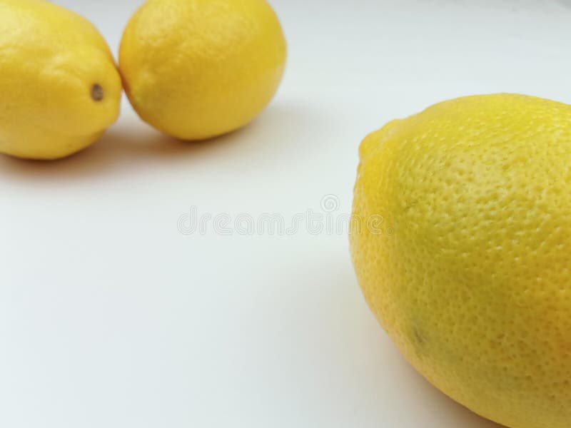 Whole lemons partially visible on white background with copy space stock photos
