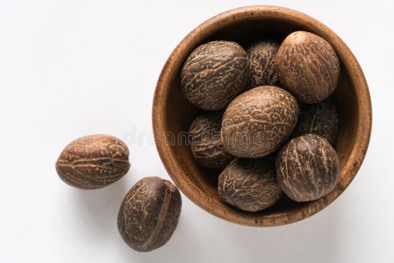 Whole Nutmeg in a Bowl stock photo. Image of ingredient 169630662