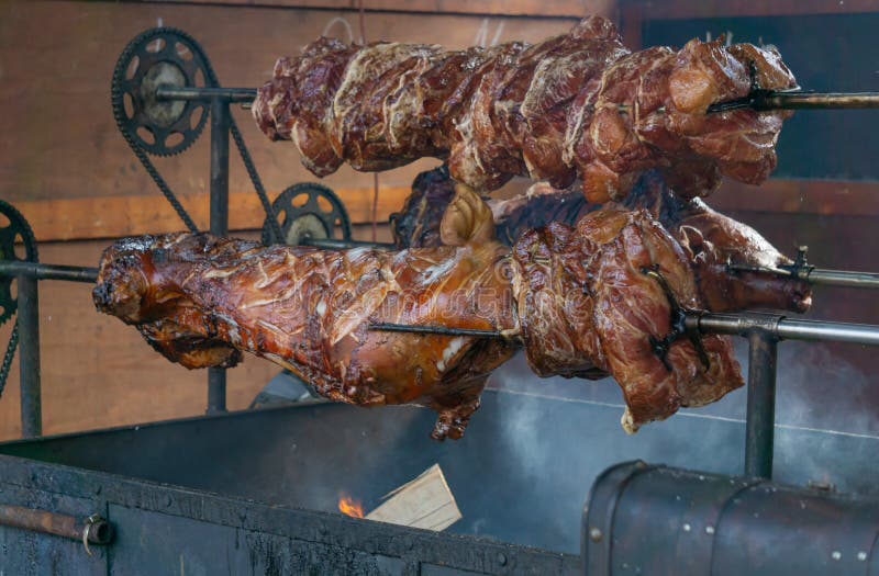 Whole Pig on the Rotisserie Being Cooked Stock Photo Image of plate