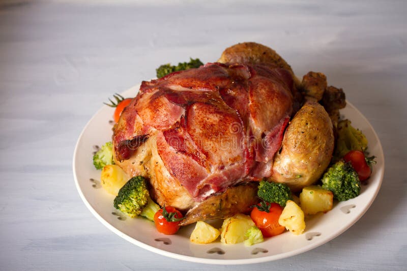 Whole Roast Chicken with Breasts Wrapped in Bacon and Vegetables