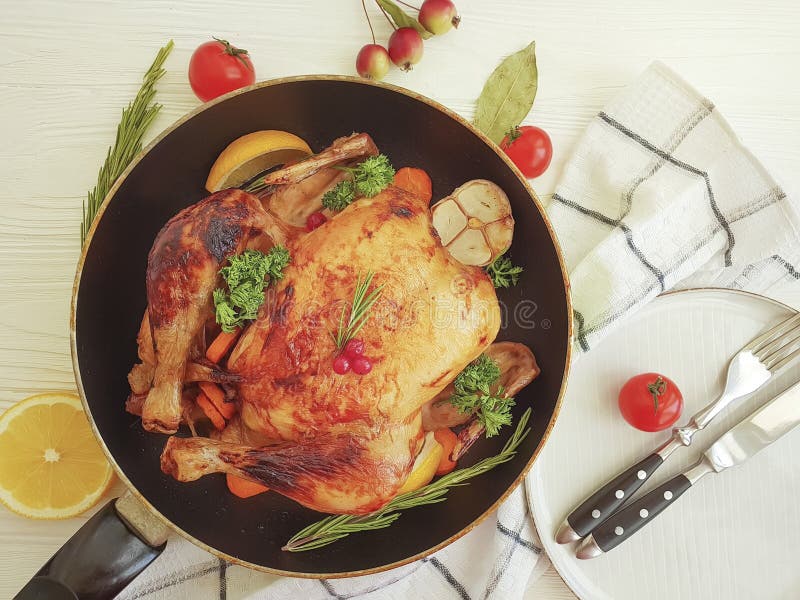 Whole Roast Chicken, Garlic Tomato, Lemon on a Table White Background