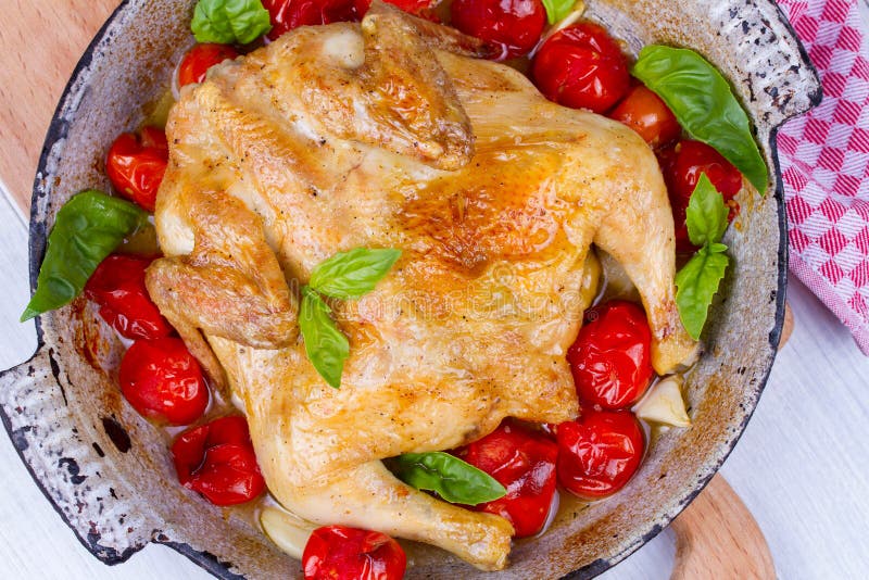 Whole Roast Chicken with Tomatoes Cherry, Green Basil and Garlic. Stock
